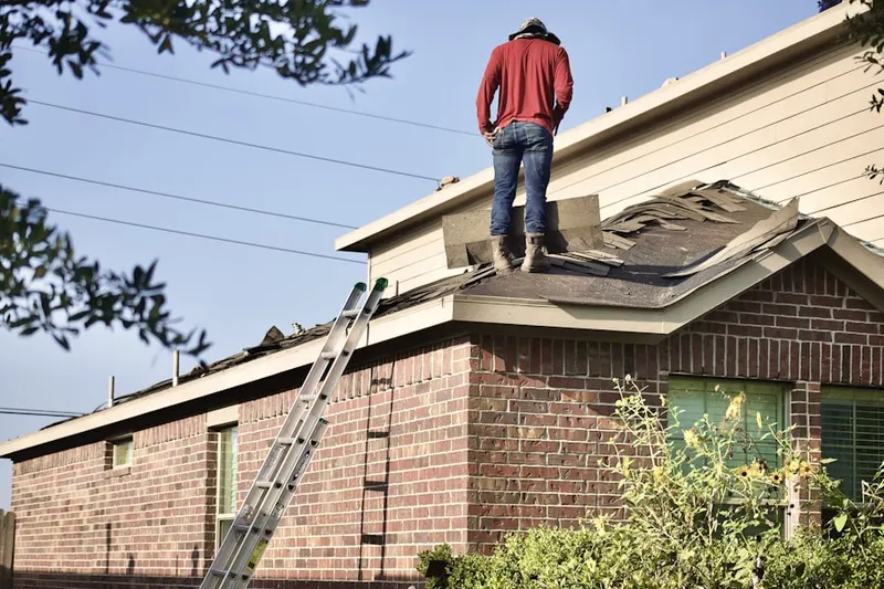 Professional roofer working on a residential roof in Broomall